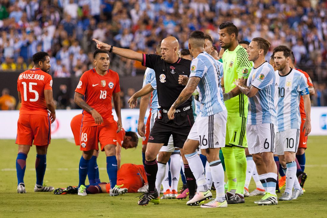 Referee Heber Lopes orders Argentina's Marcos Rojo (16) off the pitch after giving him a red card in the 43rd minute.